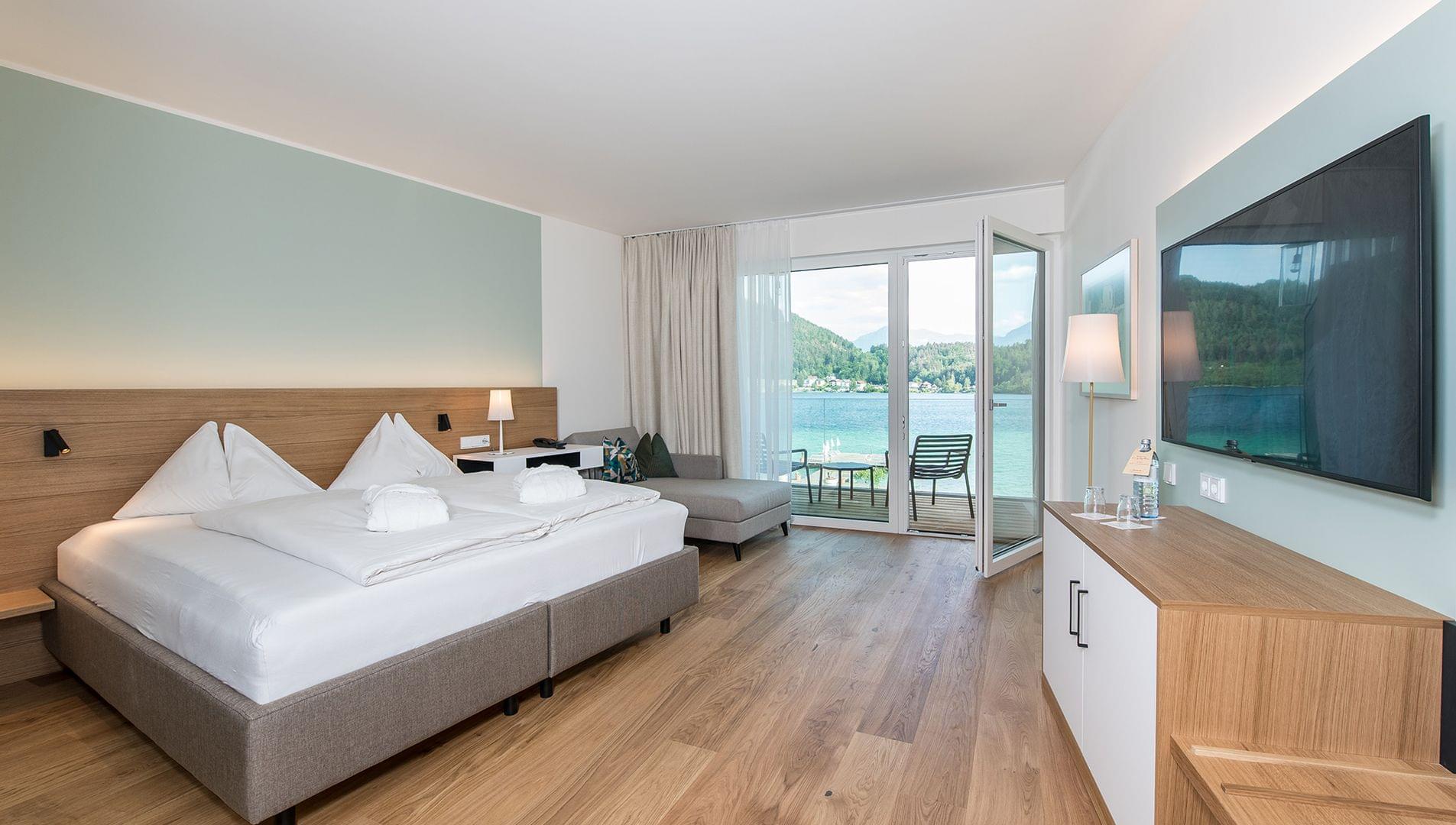 Doppelzimmer Morgentau Doppelbett vor türkiser Wand mit Blick auf Balkon